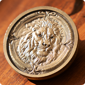 Laser engraved metal medallion with detailed lion relief pattern