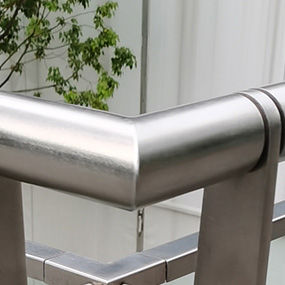 Brushed stainless steel handrail corner with smooth weld finishing and uniform surface treatment