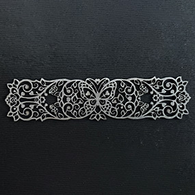 Fine laser cut metal detail with precise ornamental pattern
