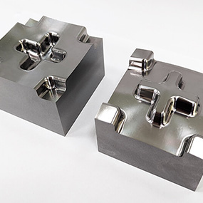 Polished precision machined metal blocks with clean pockets and finished faces for engineering applications