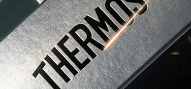 Laser marking equipment labels on a metal control panel part